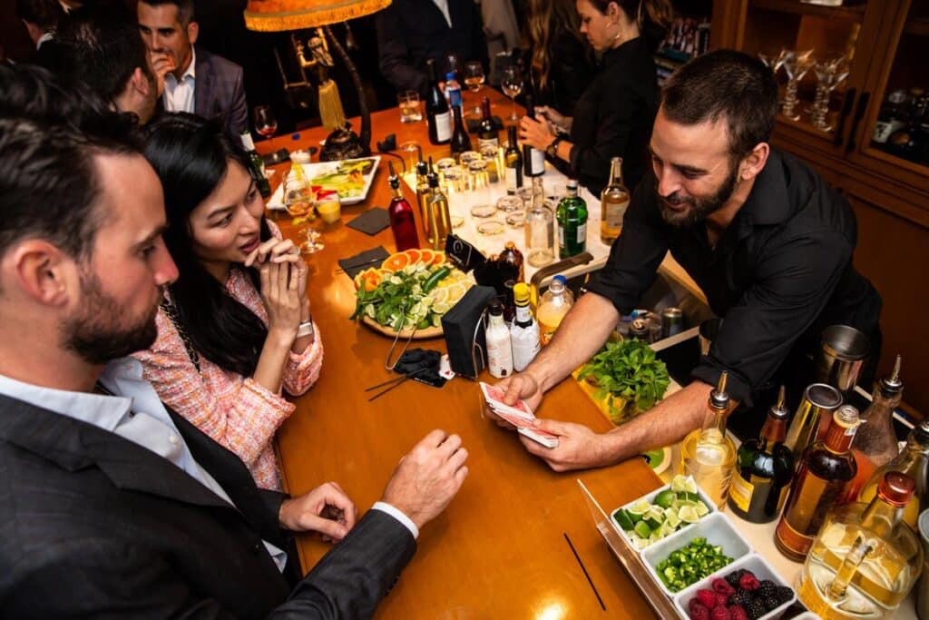 Magic&Cocktail bartender performing a card trick