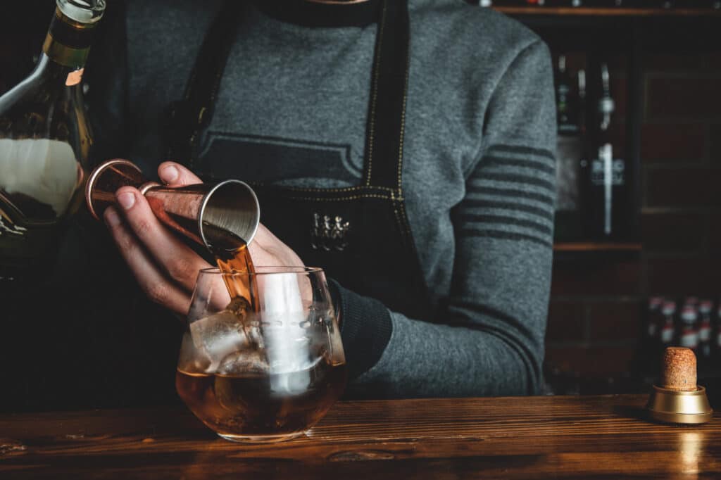 bartender making the whiskey martini cocktail